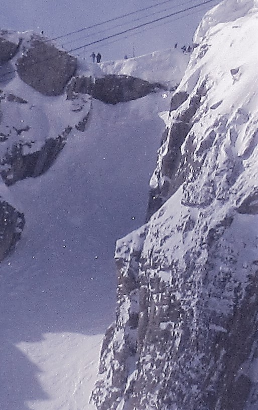 Skiers stand at the top of Corbets Couloir