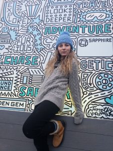 Young girl poses at Instagram worthy wall art