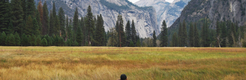 Couple looking at landscape in Yosemite National Park in the Yosemite Valley, California. Photo by Anneliese Phillips